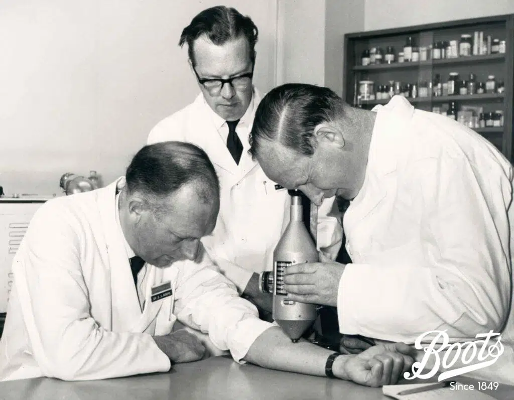 Photograph of Dr Stewart Adams, Dr John Nicholson, and Mr Ray Cobb measuring inflammatory levels published in Boots staff magazine, The Beacon, June-July 1969