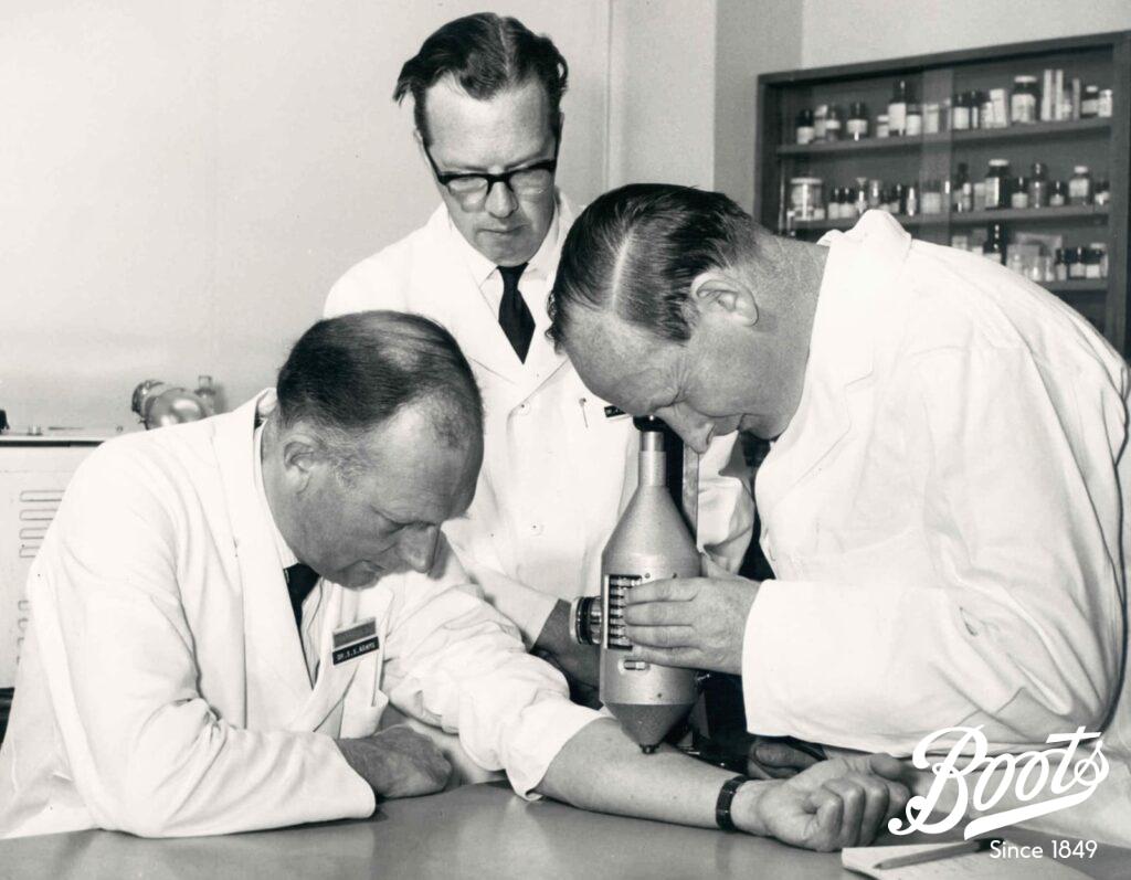 Ibuprofen: A discovery of global significance 6 Photograph of Dr Stewart Adams, Dr John Nicholson, and Mr R Cobb measuring inflammatory levels published in Boots staff magazine, The Beacon, June-July 1969.